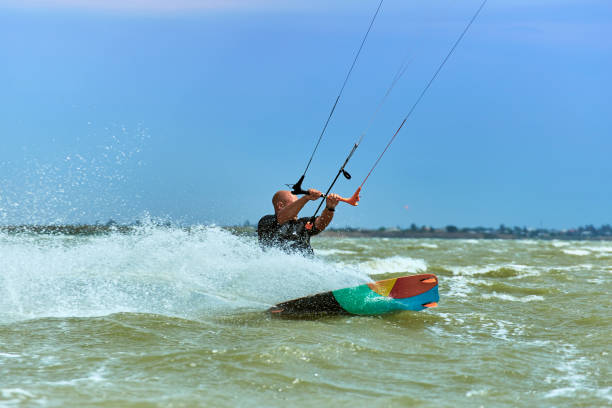 istock Man riding a kite surfing on the waves in the summer. 843653480