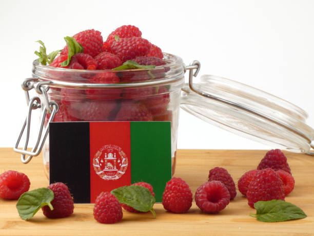 istock Afghanistan flag on a wooden panel with raspberries isolated on a white background 843656046