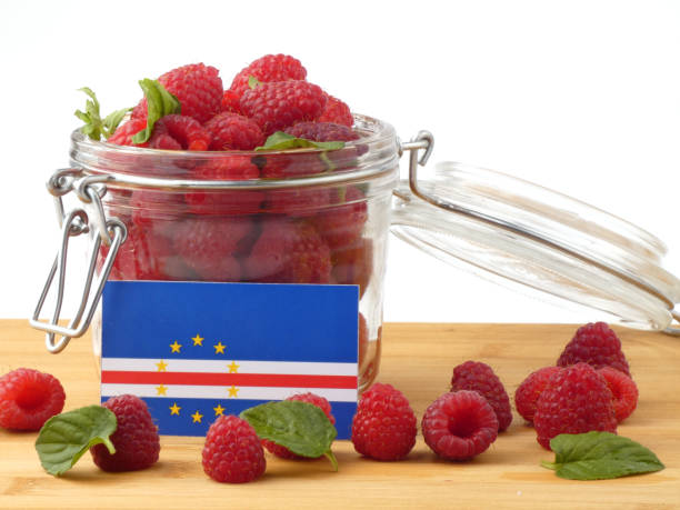 istock Cape Verde flag on a wooden panel with raspberries isolated on a white background 843656144
