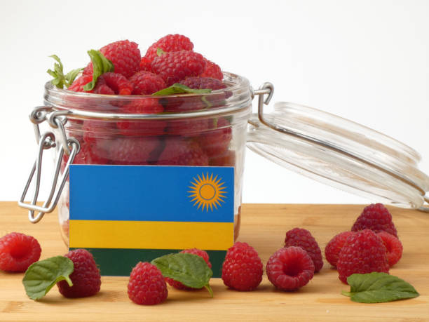 istock Rwanda flag on a wooden panel with raspberries isolated on a white background 843656756