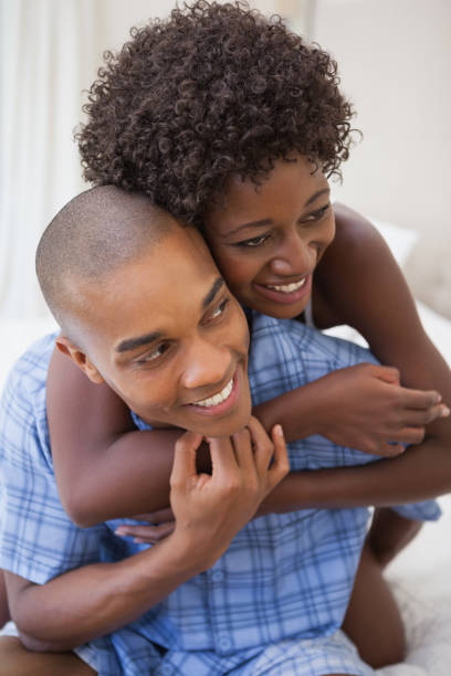 istock Happy couple messing about in bed together 843656894
