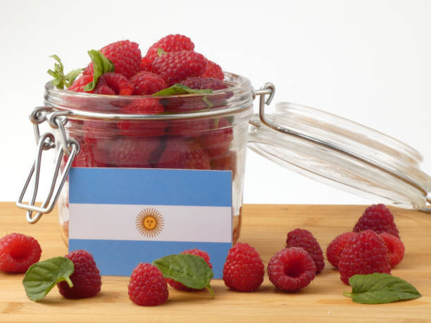 istock Argentinian flag on a wooden panel with raspberries isolated on a white background 843657042