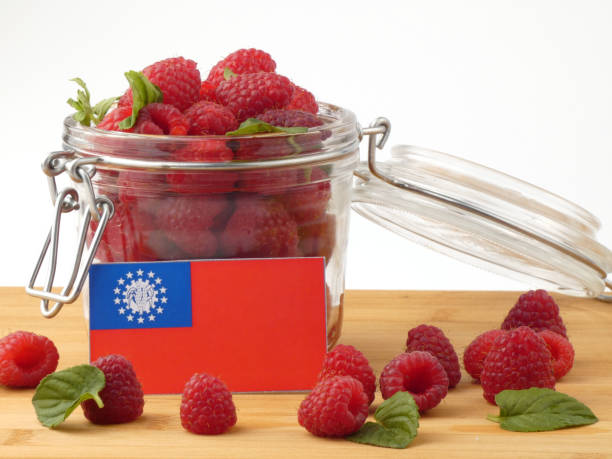 istock Myanmar flag on a wooden panel with raspberries isolated on a white background 843657304