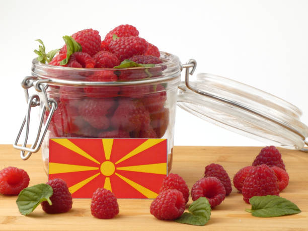 istock Macedonian flag on a wooden panel with raspberries isolated on a white background 843657512