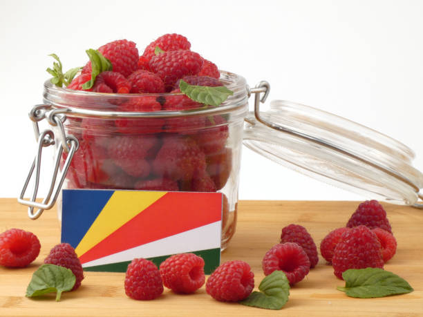 istock Seychelles flag on a wooden panel with raspberries isolated on a white background 843658416
