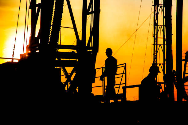 istock oil field, the oil workers are working 843658650