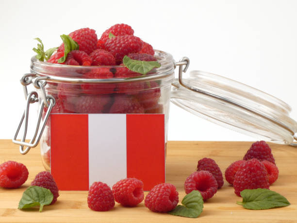 istock Peruvian flag on a wooden panel with raspberries isolated on a white background 843658912