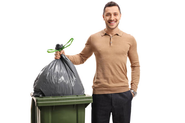 istock Young man throwing out the garbage and smiling 843661290