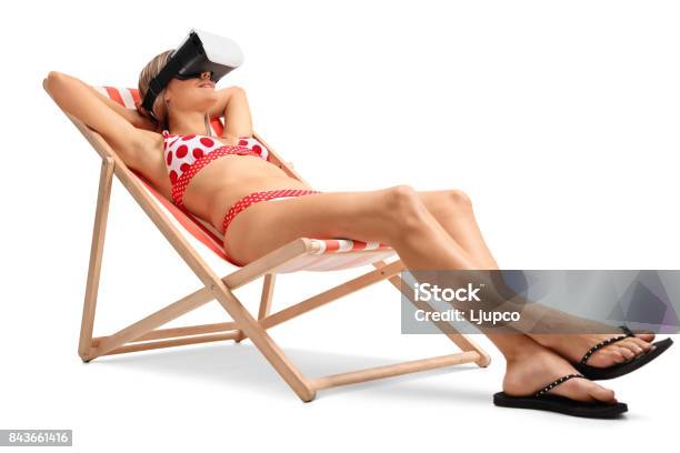 Young Woman With A Vr Headset Lying In A Deck Chair Stock Photo - Download Image Now
