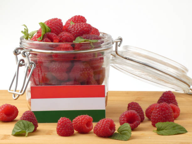 istock Hungarian flag on a wooden panel with raspberries isolated on a white background 843661822
