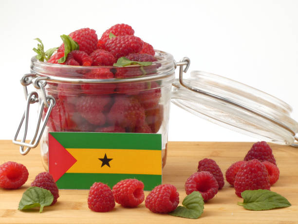 istock Sao Tome and Principe flag on a wooden panel with raspberries isolated on a white background 843662066