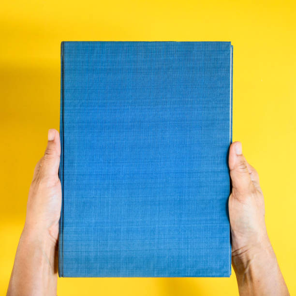 istock top view mock up book on hand and magazine text 843662302