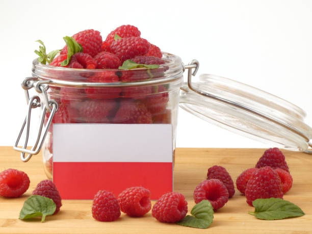 istock Polish flag on a wooden panel with raspberries isolated on a white background 843662316