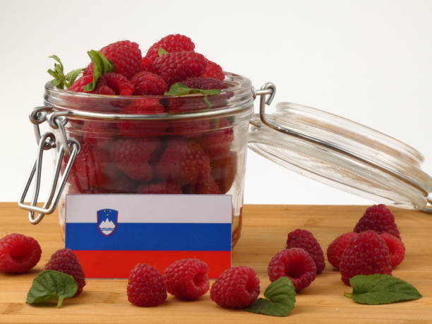 istock Slovenian flag on a wooden panel with raspberries isolated on a white background 843662592