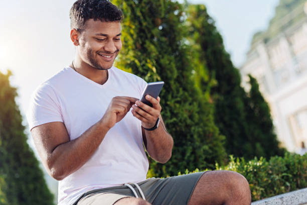 istock Portrait of positive student that playing with his gadget 843663474