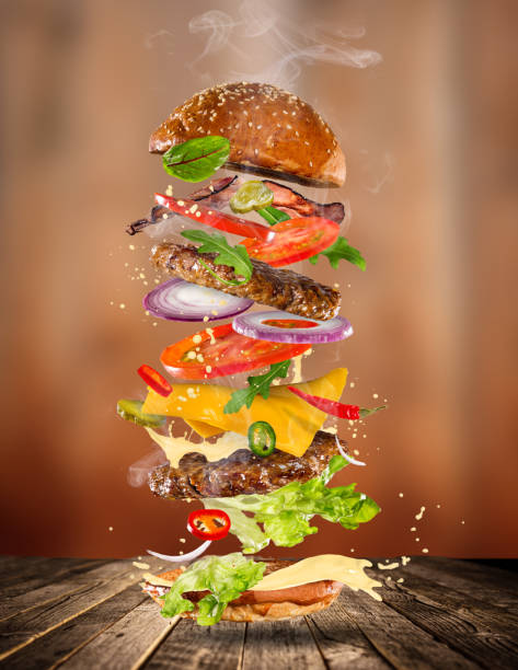 istock Big tasty burger with flying ingredients 843666222