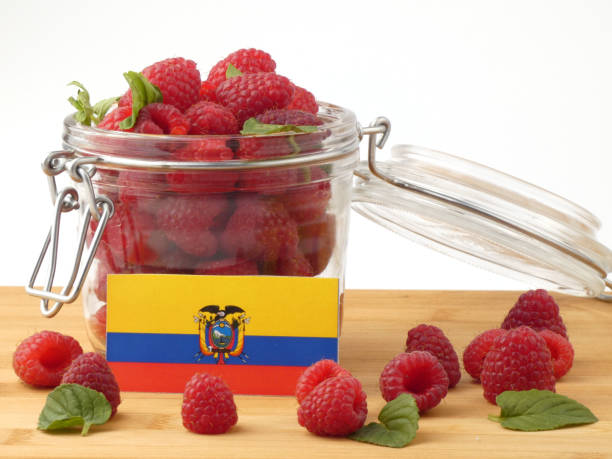 istock Ecuador flag on a wooden panel with raspberries isolated on a white background 843666578