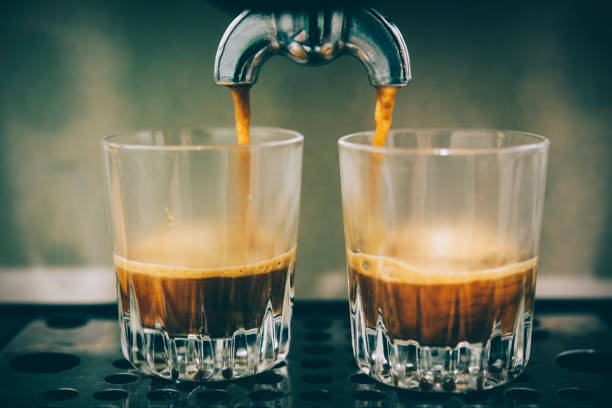 istock Brewing Espresso Coffee into two shot glasses. 843666588