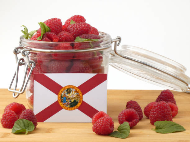 istock Florida flag on a wooden panel with raspberries isolated on a white background 843666870