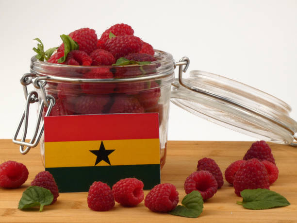 istock Ghanaian flag on a wooden panel with raspberries isolated on a white background 843666980