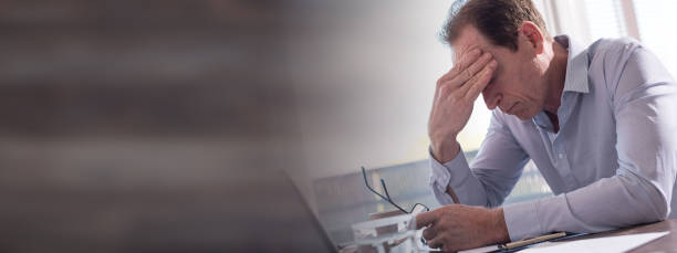 istock Stressed businessman sitting in office 843671834