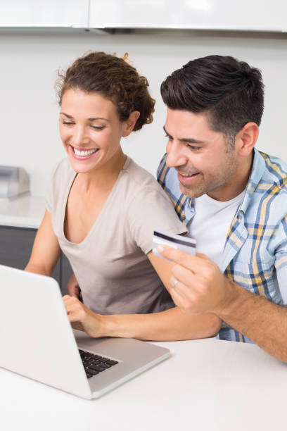 istock Happy couple using laptop together to shop online 843672388