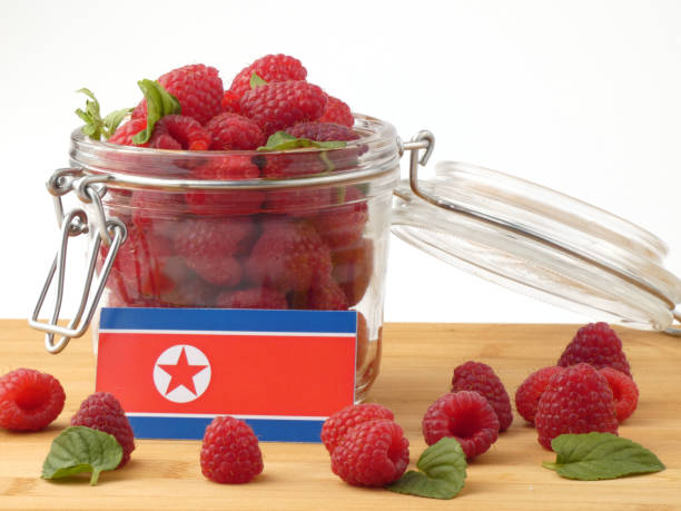 istock North Korean flag on a wooden panel with raspberries isolated on a white background 843672394