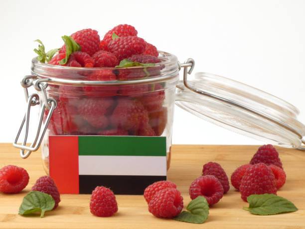 istock United Arab Emirates flag on a wooden panel with raspberries isolated on a white background 843672666