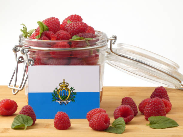istock San Marino flag on a wooden panel with raspberries isolated on a white background 843672804
