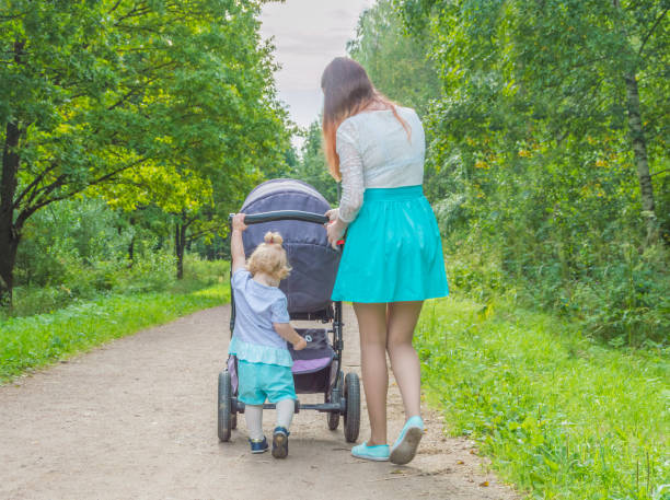 istock child in the Park pushing a stroller 843673454