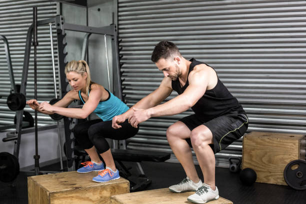 istock Couple doing box jumps in gym 843676100
