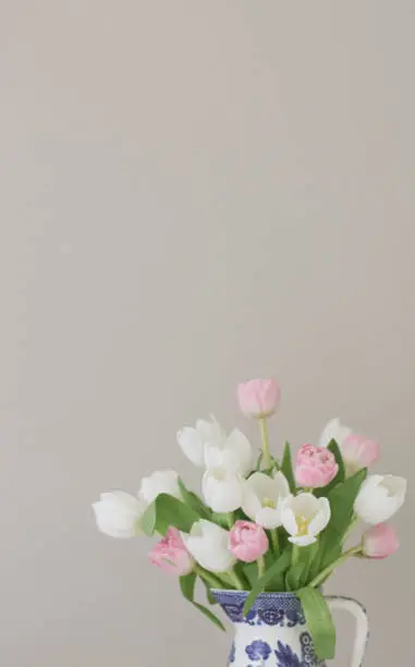 Romantic pink and white tulips in a vintage chinois vase