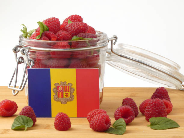istock Andorra flag on a wooden panel with raspberries isolated on a white background 843677208