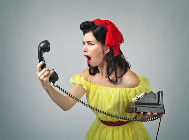 istock Young woman screaming into a phone . 843677746