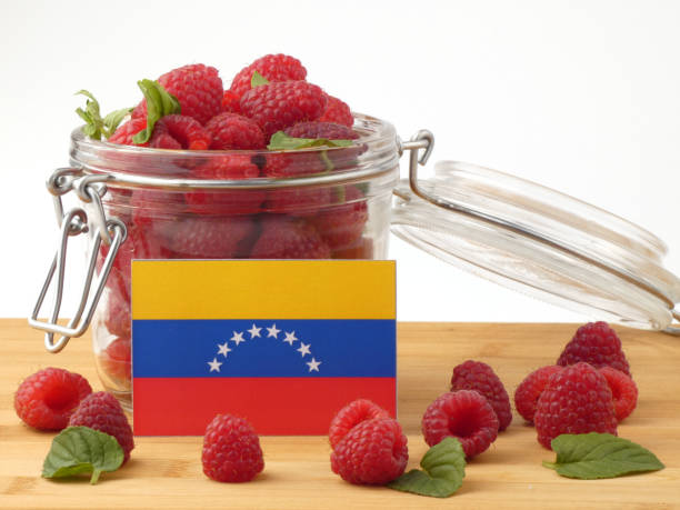 istock Venezuelan flag on a wooden panel with raspberries isolated on a white background 843681234