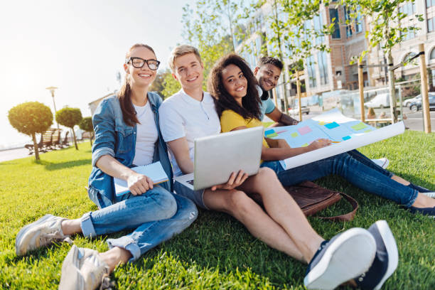 istock Relaxed young people sitting on the grass 843681264