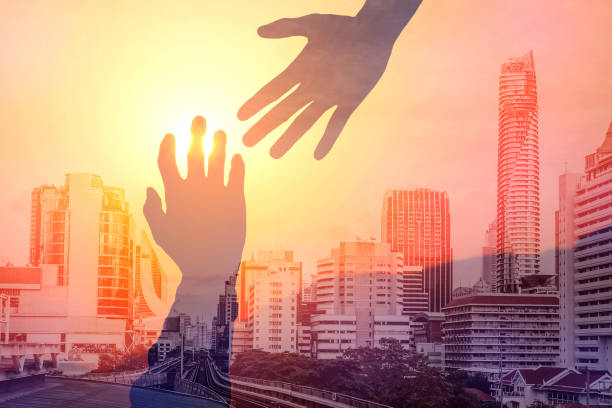 istock Helping hands concept in urban city 843681470