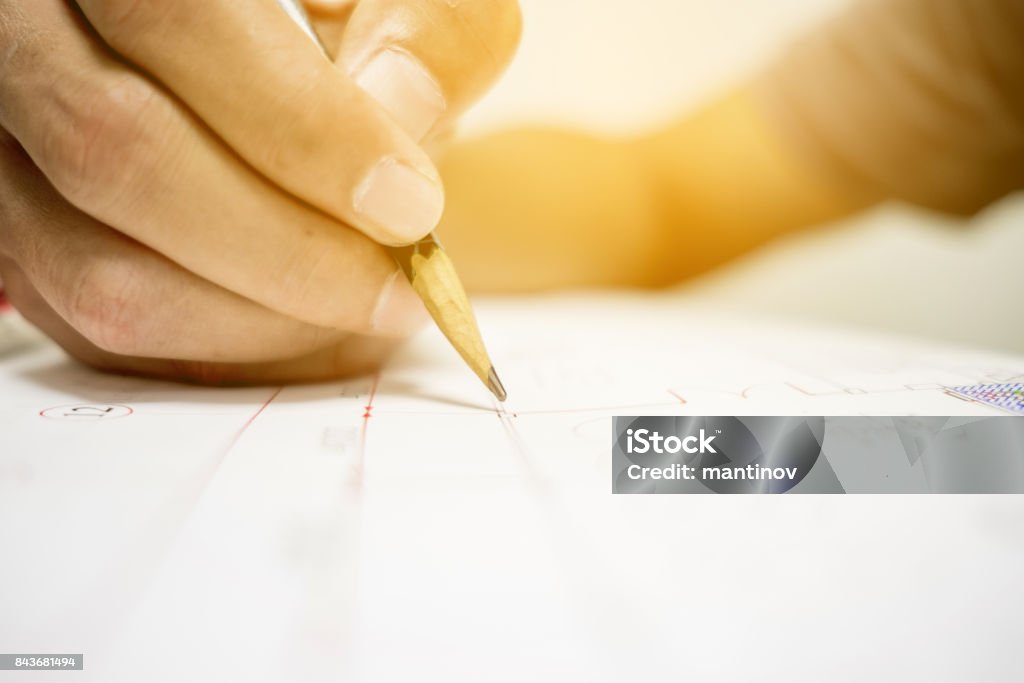 engineer and drawing paper Engineer are measuring distance in drawing using pencil and ruler. Surveyor Stock Photo