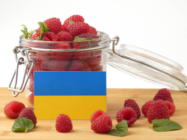 istock Ukraine flag on a wooden panel with raspberries isolated on a white background 843681672