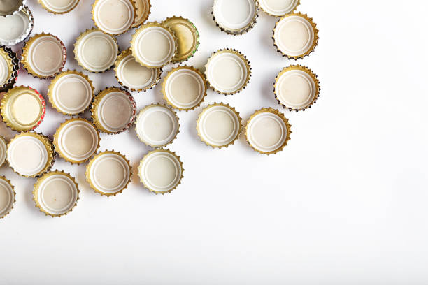 istock many upturned lids from beer scattered on a white background 843686188