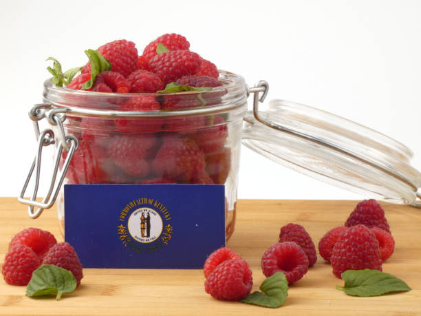 istock Kentucky flag on a wooden panel with raspberries isolated on a white background 843689274