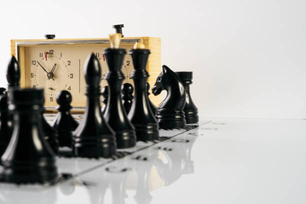 istock Old stopwatch, chess pieces and a chessboard 843689666