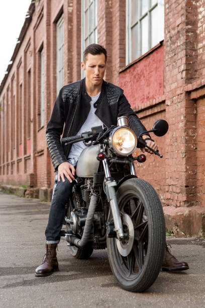 istock Brutal man sit on cafe racer custom motorbike. 843690764
