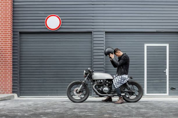 istock Brutal man sit on cafe racer custom motorbike. 843690954