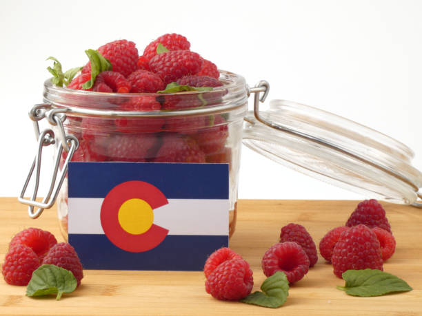 istock Colorado flag on a wooden panel with raspberries isolated on a white background 843691308