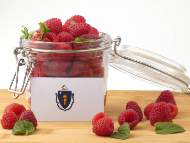 istock Massachusetts flag on a wooden panel with raspberries isolated on a white background 843692084