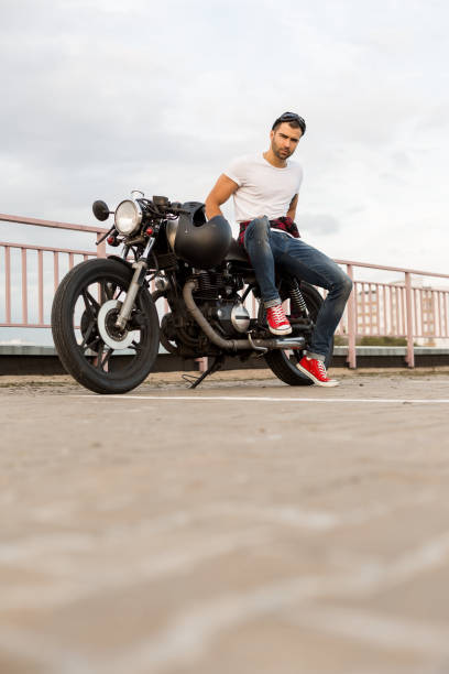 istock Brutal man sit on cafe racer custom motorbike. 843692700