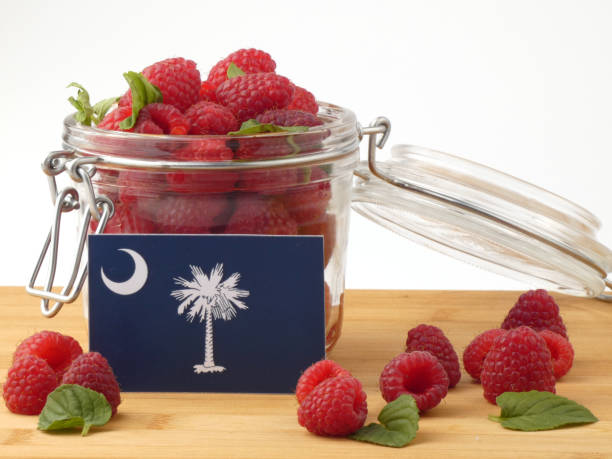 istock South Carolina flag on a wooden panel with raspberries isolated on a white background 843693534