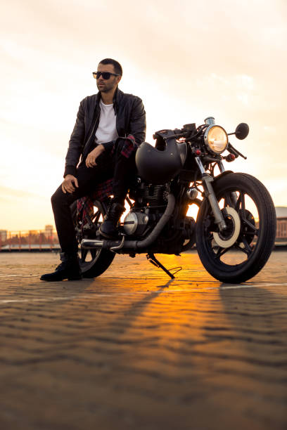 istock Brutal man sit on cafe racer custom motorbike. 843695884