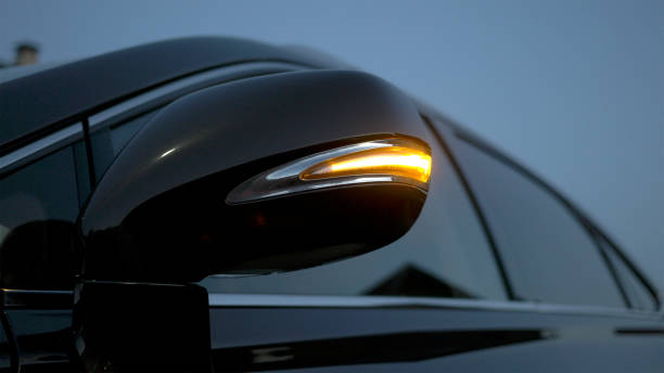 istock Car rear-view mirror. Direction indicator is flashing at evening. Modern car interior 843697010